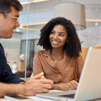 Woman speaks to man while sat at table